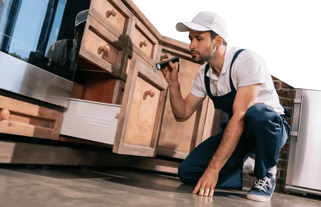 A person inspecting kitchen drawers
