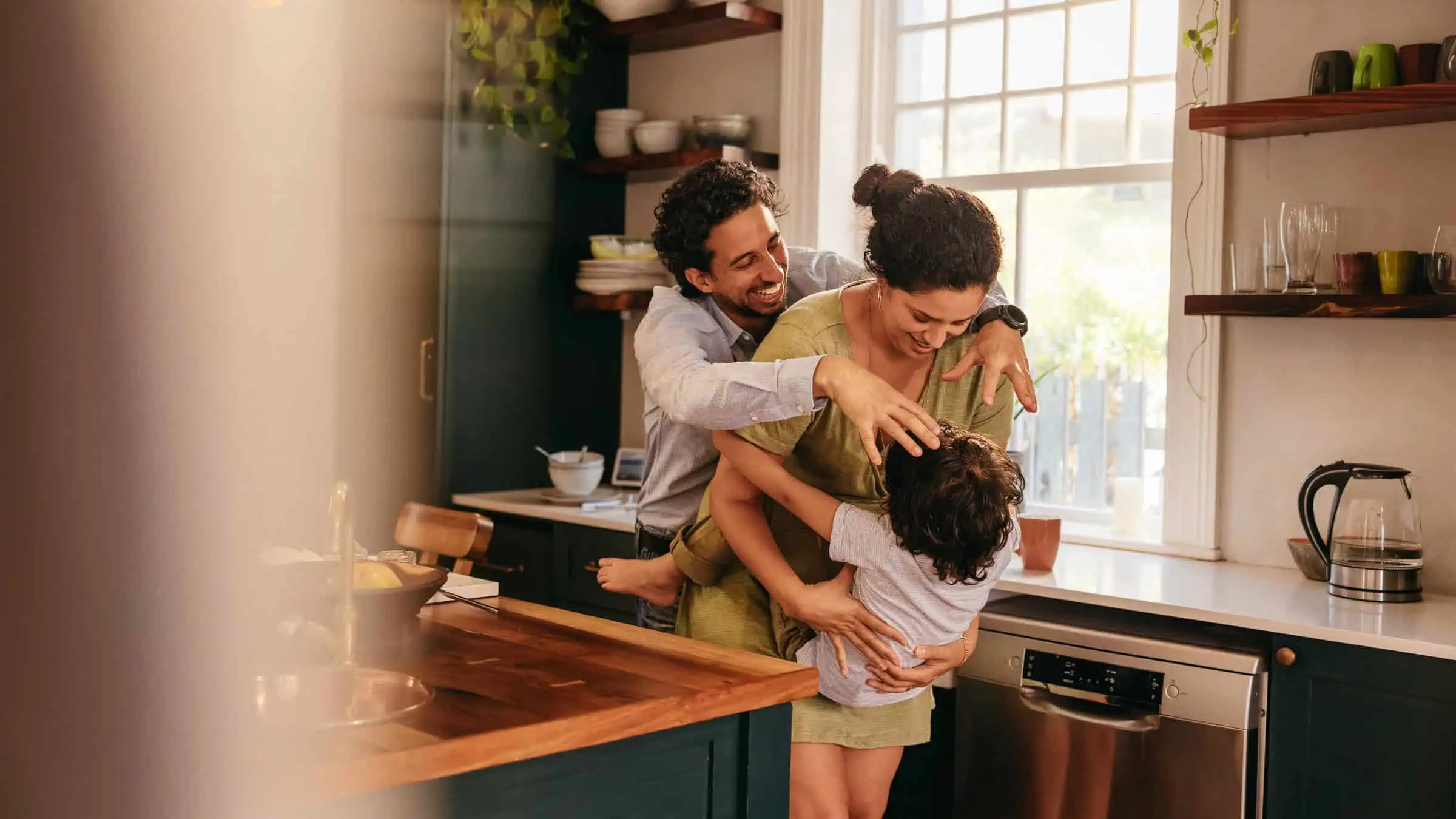 Family being playful in the kitchen
