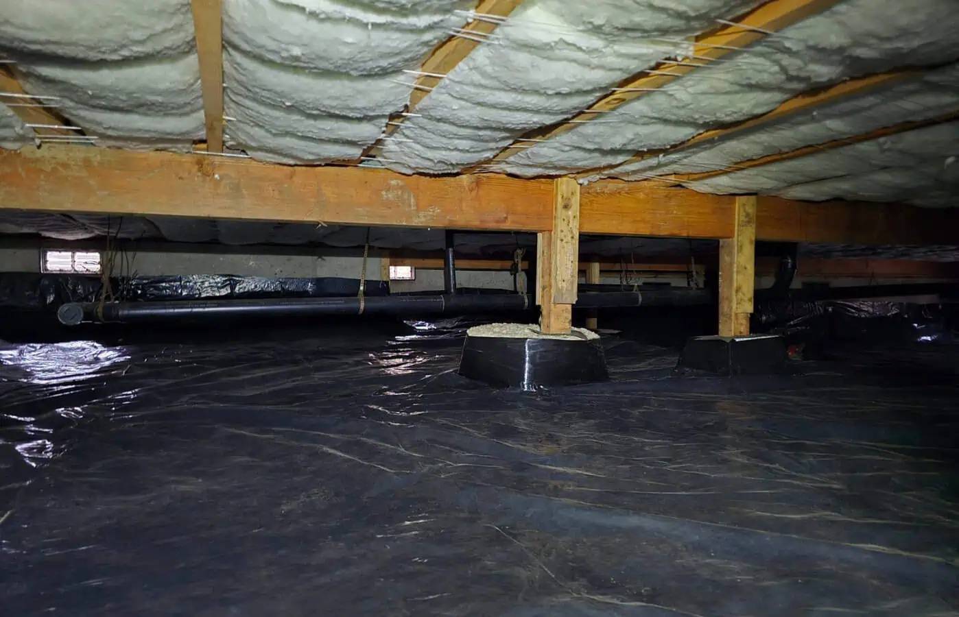 crawlspace with new insulation and moisture barrier